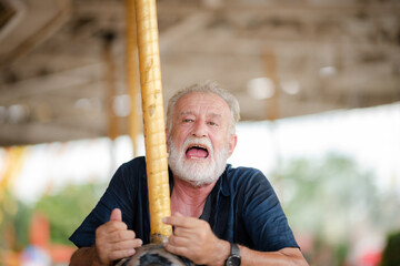 elderly senior couple woman and man having fun and happy together at amusement them park