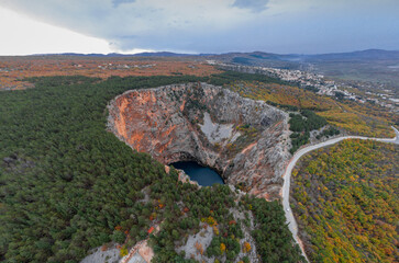 Fototapeta na wymiar Magnificent and majestic red lake close to Imotski, a crater or sinkhole in limestone filled with water, more than 500m deep. Aerial drone photo.