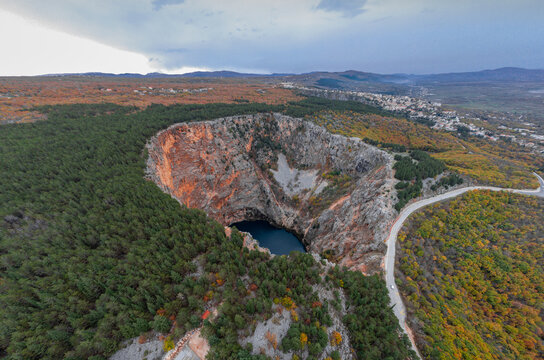 Magnificent and majestic red lake close to Imotski, a crater or sinkhole in limestone filled with water, more than 500m deep. Aerial drone photo.