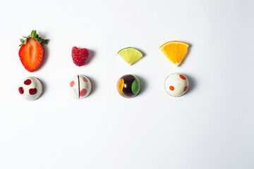 Mexican colorful chocolate candy bonbons with fruits on white background