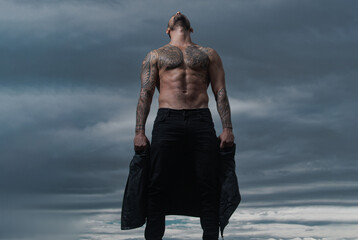 Strong muscular male body, muscles guy. Fashion male model with leather jacket. Sexy gay.