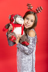 portrait of a beautiful girl in a gray shiny dress. holiday, new year, christmas, tree