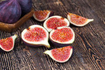 ripe purple figs on a wooden table