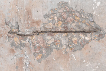 Textured grunge background. An old wall with a peeling cover and a deep pattern. Beige pink background