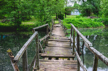 A wobbly wooden bridge over the handle leading to the other side and into the village