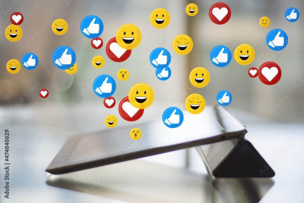 Poster close up of tablet on desktop with social media icons. blurry background. communication, internet an