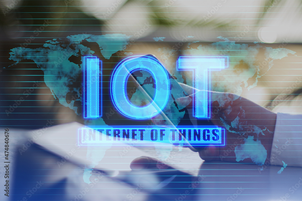Poster Close up of hands using tablet and smartphone with creative glowing blue IOT and map hologram on blurry background. Internet of things concept. Double exposure.