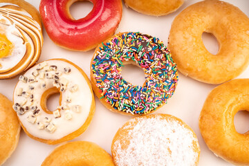 1 dozen mixed donuts, original flavor, chocolate, marmalade and fancy toppings on white background.
