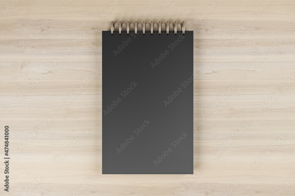 Poster top view and close up of black spring note pad on wooden desktop background. mock up place for your 