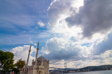 Fototapeta premium Ortakoy Mosque. Ortakoy Mosque and Bosphorus Bridge with cloudy sky in Istanbul