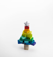 Naklejka premium Low poly like, Christmas tree made form colorful wooden blocks. Christmas in colorful spectrum of colors. 