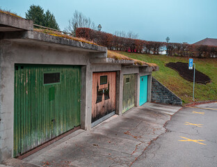 Gruyeres, Switzerland - November 23, 2021: Generic garage building with garage doors in different colors