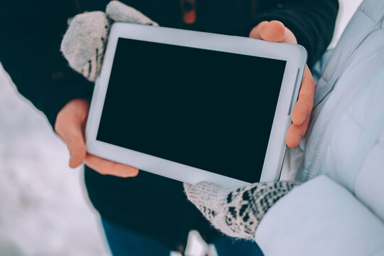 couple demonstration tablet with empty screen. advertising winter theme