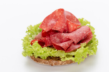 Sandwich with salami sausage on white background.