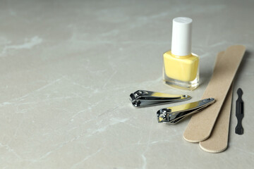 Concept of nail care with manicure accessories on light textured background