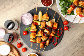Concept of tasty food with chicken shashlik on light wooden background