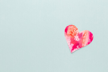 Cut the heart shaped paper, put on a pastel background.