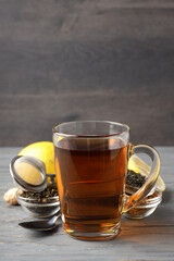 Concept of hot drink with tea on gray wooden table