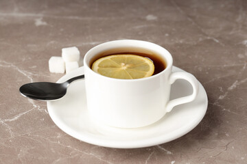 Concept of hot drink with tea on beige textured background