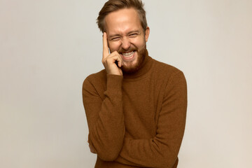 Studio shot of charming charismatic sincerely laughing self-deprecating man, standing against white...