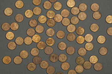Polish one-grosz coins scattered on a dark gray background.