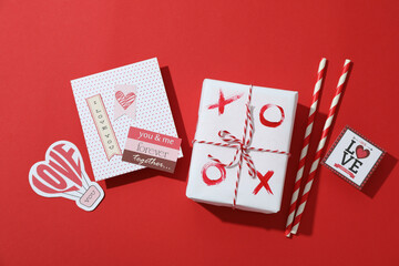 Valentine's Day accessories on red background, top view