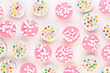 Colorful cupcakes on a white background.