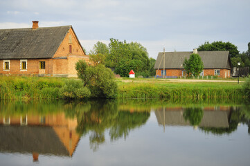 Obraz premium house on the river bank