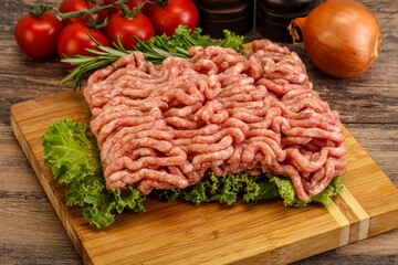 Raw pork minced meat over board