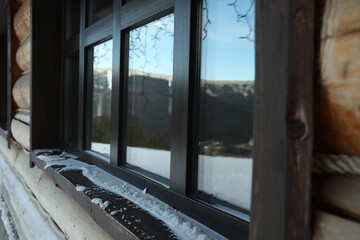 Fototapeta na wymiar Windowsill of wooden house outdoor in mountains