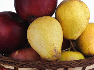 Apples and pears in the basket. Natural fruits.