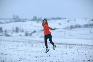 winter snow field woman happiness jumping and running in the field, new year holidays vacation freedom concept