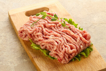 Raw minced pork meat over board
