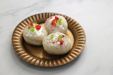 Rasmalai or Malai Sandwich, Roshmolai, Rasamalei is very popular Indian dessert. A sweet malai stuffing inside Rasgulla. It's a sweet delicacy made with Indian cottage cheese or chenna. Copy space.