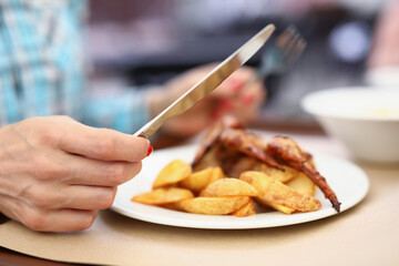 Person having breakfast or lunch in cafe or restaurant, hold knife and fork