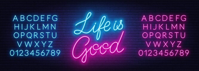 Life is Good neon lettering on brick wall background.
