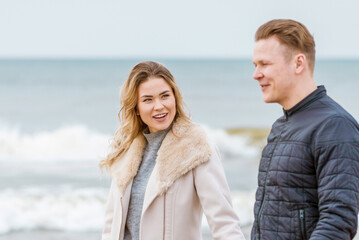 Obraz premium Young loving couple spending time together at spring beach.Blur background,close up.