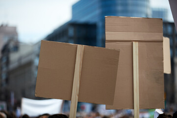 Protesters holding placards and signs on the streets.