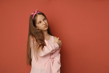 Fototapeta premium A teenage girl with a patch on her arm after vaccination. The girl frowns. Space for text, vaccination concept. High-quality photography