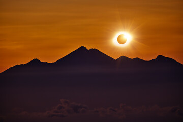 Solar eclipse on a colorful sky.