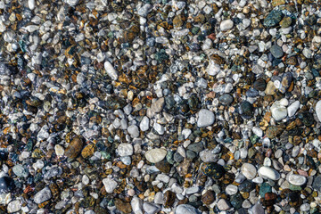 Wet sea pebbles. Pebbles on the sea