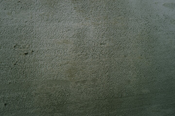 Surface of fresh cement plaster. Texture of gray wet plaster on the wall on construction site.