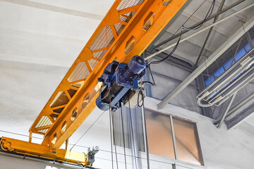 In the metalworking workshop there is a working electric drive of an overhead crane.