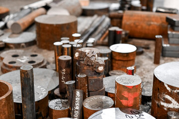 Rusty metal for the product lie on the floor in the workshop.