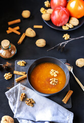 Persimmon fruit smashed in a bowl on the dark background