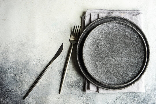 Minimalistic black place setting with plate and cutlery