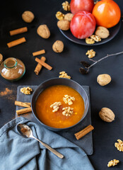 Persimmon fruit smashed in a bowl on the dark background