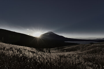 The silhouette of Mt. Fuji and the rays of the setting sun