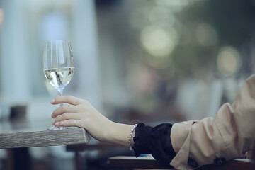 white wine glass in an outdoor cafe, spring view in a restaurant