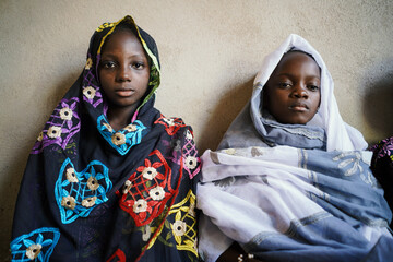 Two beautiful African girls sit together